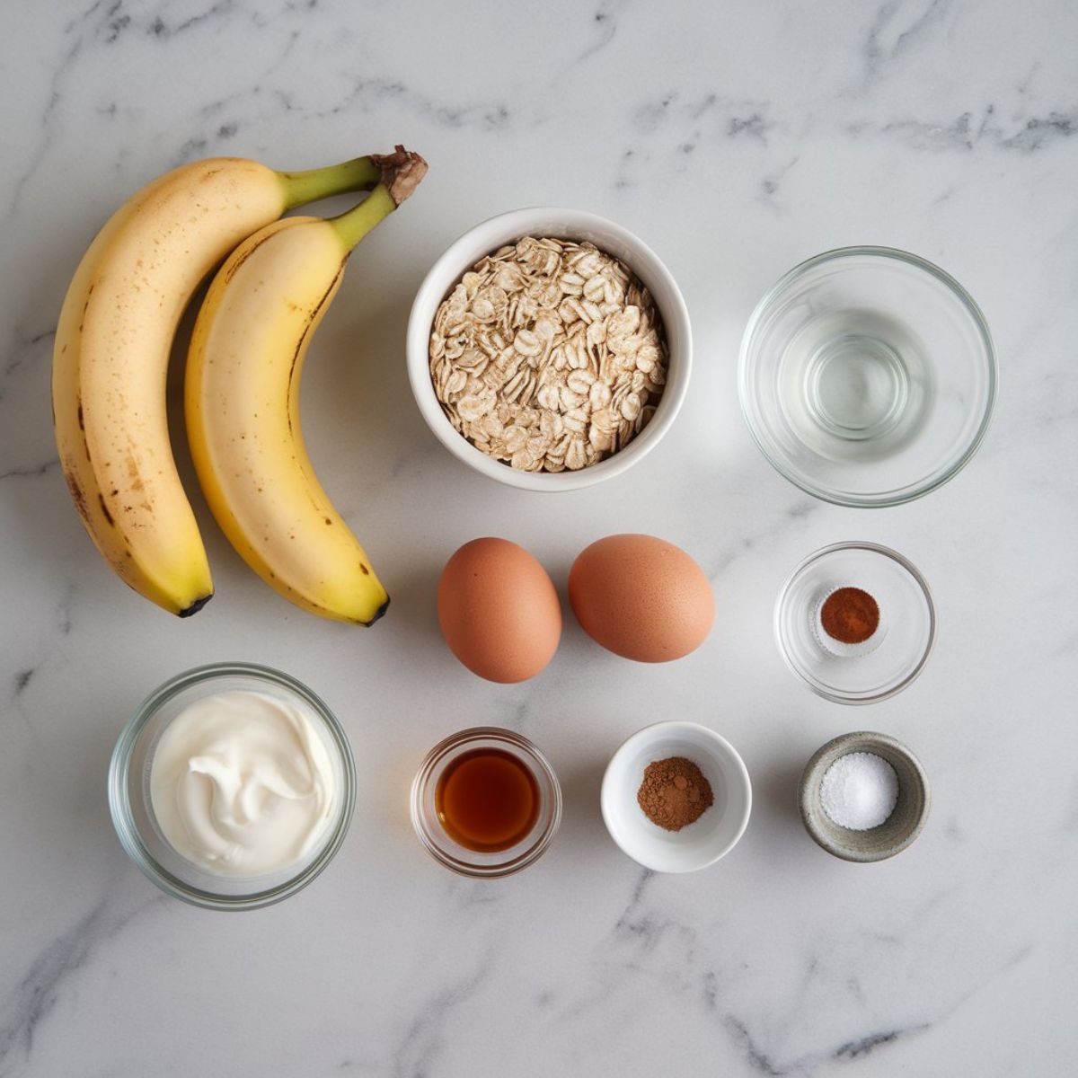 Banana Pancakes Recipe Ingredients arranged on a clean marbel kitchen contertop