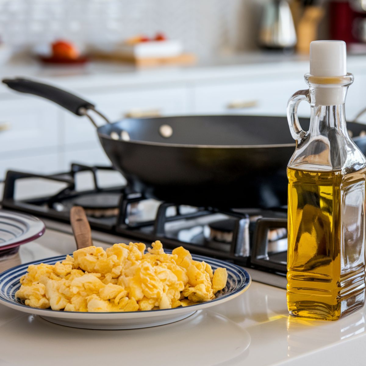 Scrambled eggs on a plate beside the wok.