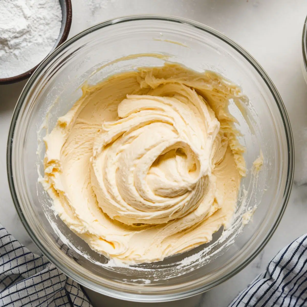 A mixing bowl with softened cream cheese.