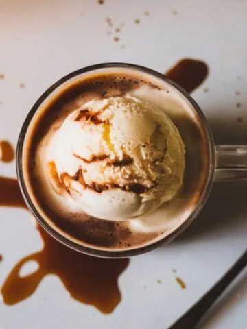 A freshly made Starbucks Affogato Coffee with vanilla ice cream melting under hot espresso, placed on a white kitchen counter.