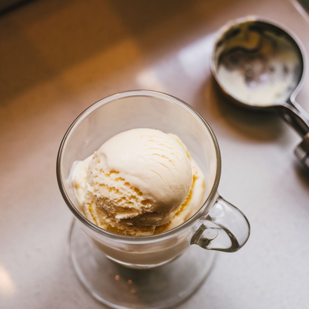 A scoop of vanilla ice cream in a chilled glass, ready for Starbucks Affogato Coffee.