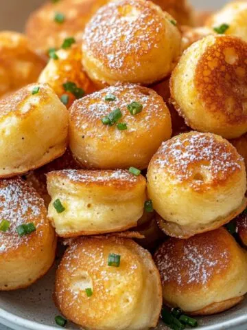 Freshly baked pancake poppers with mapple syrup and powdered sugar