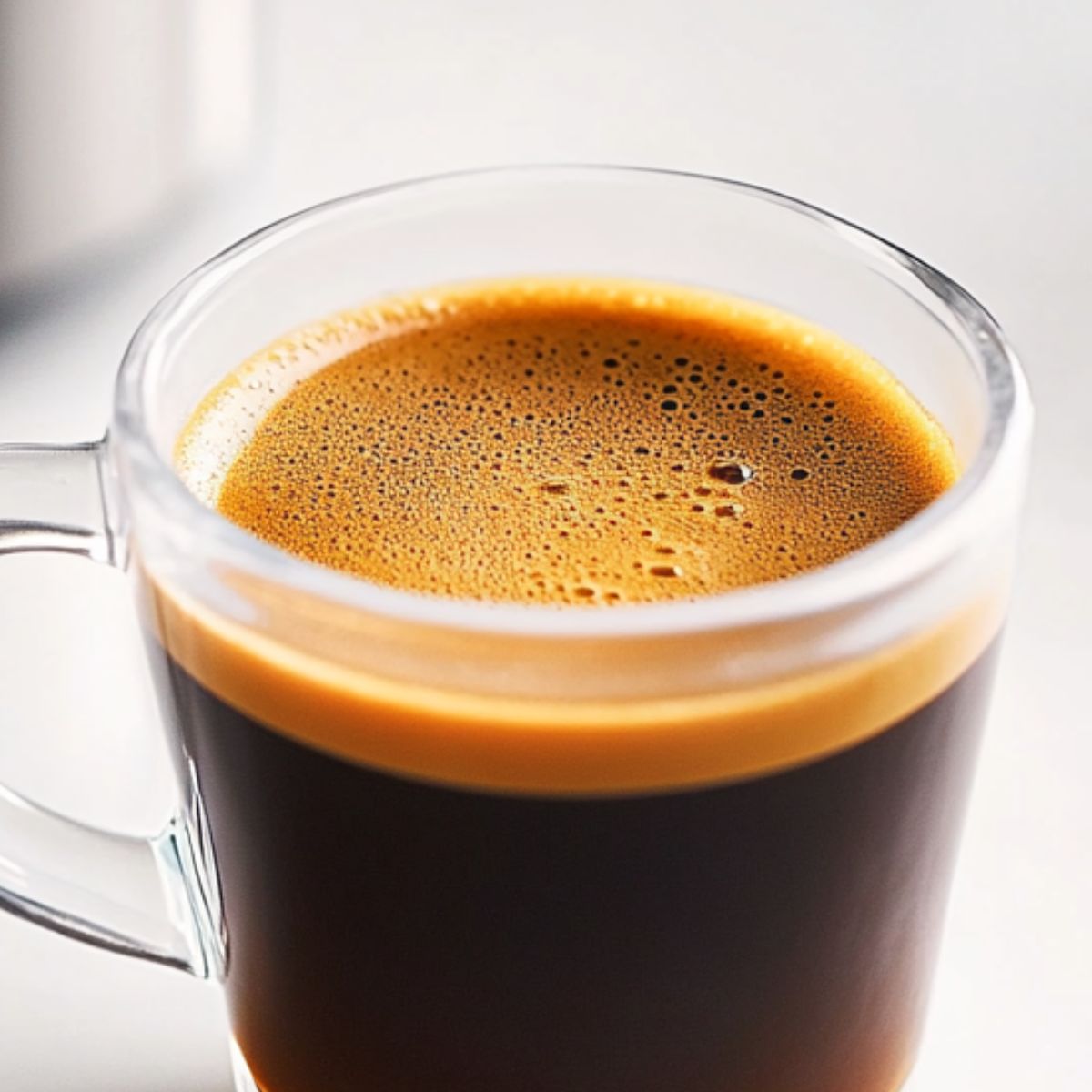 Brewed espresso cooling on a white counter as the first step to making a pink coconut iced latte.