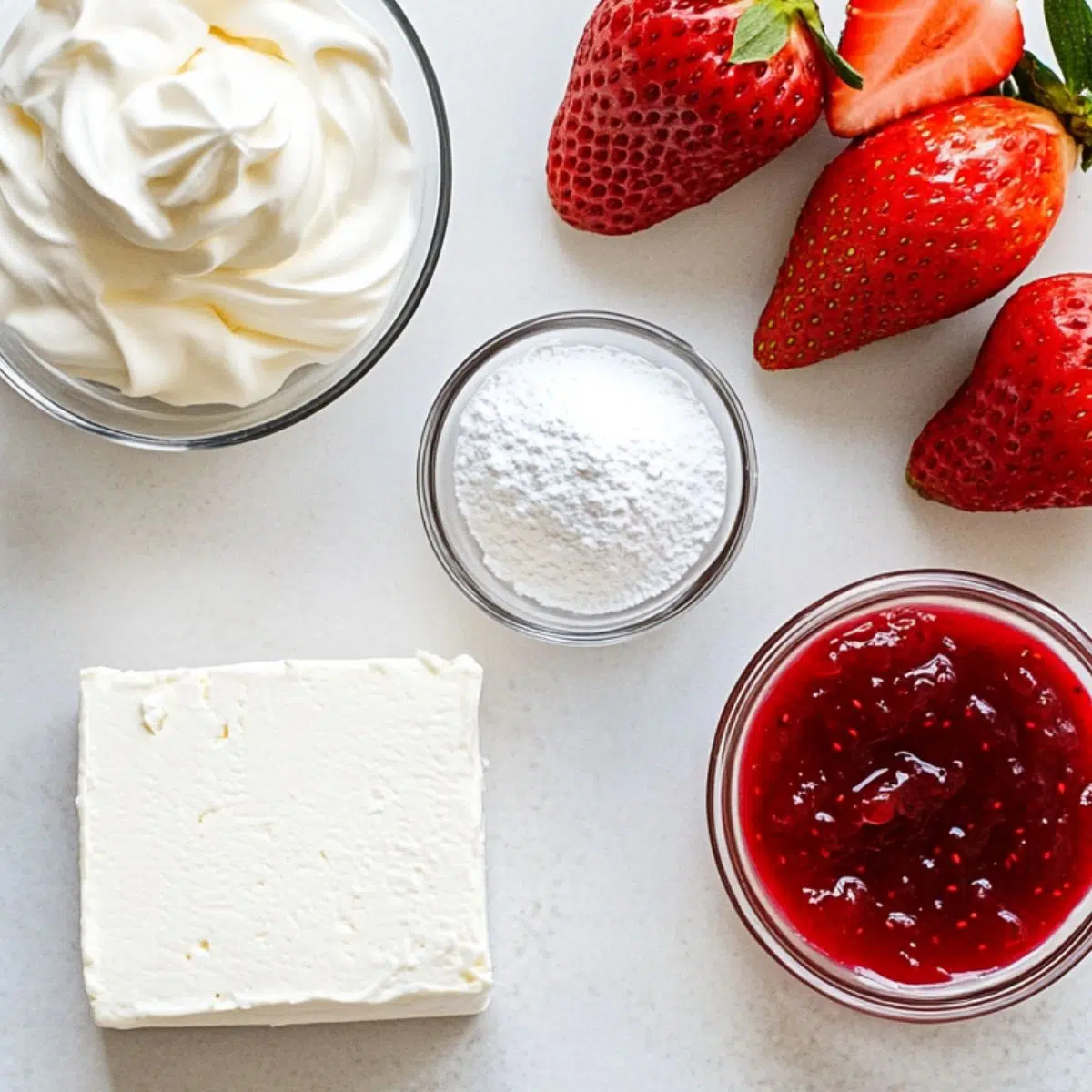 Ingredients laid out for strawberry cheesecake dip.