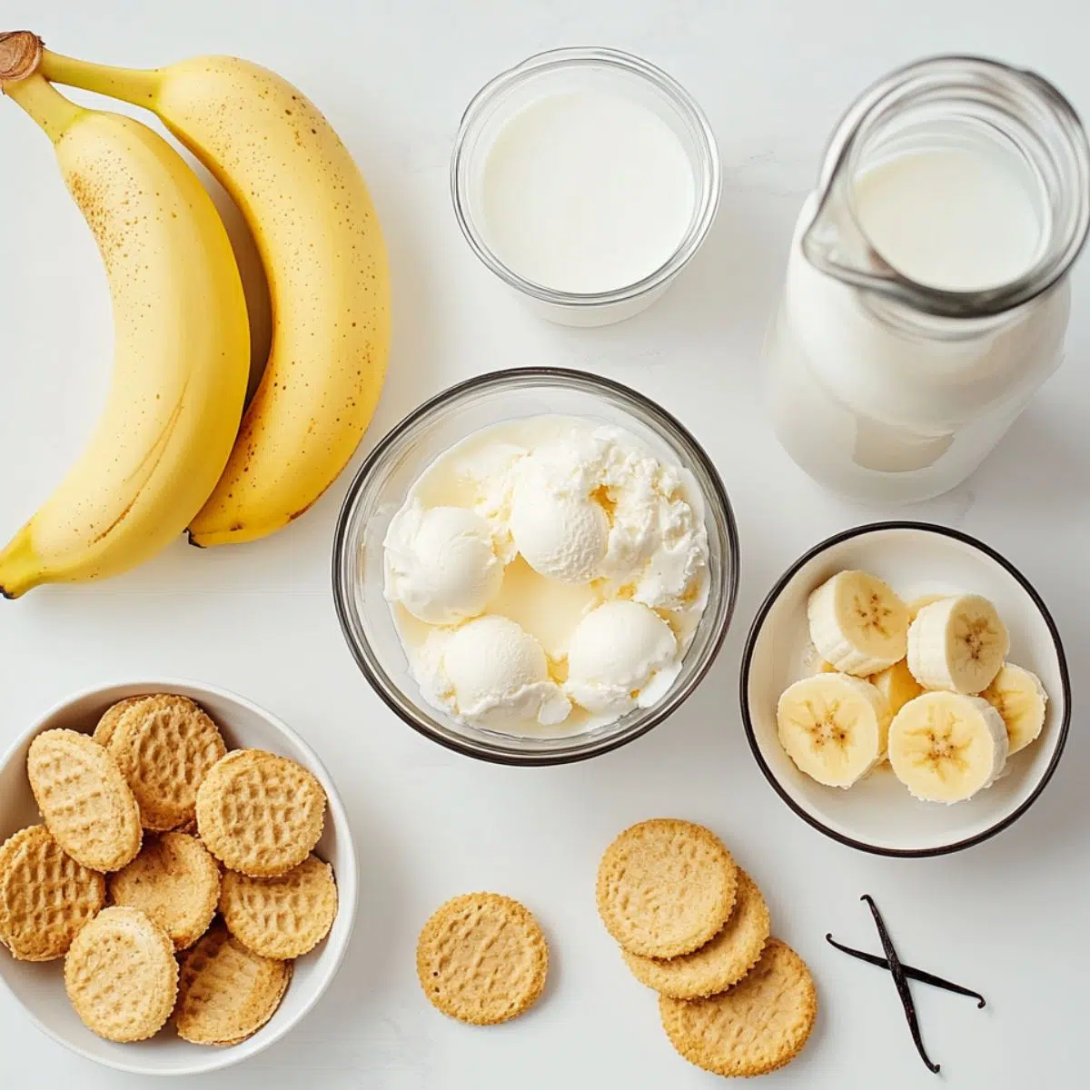  Flat lay of banana pudding milkshake ingredients on a white counter