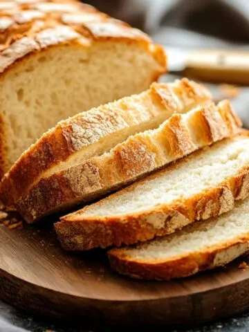 Freshly baked 3 ingredient banana bread sliced and ready to enjoy, surrounded by a cozy kitchen setting.