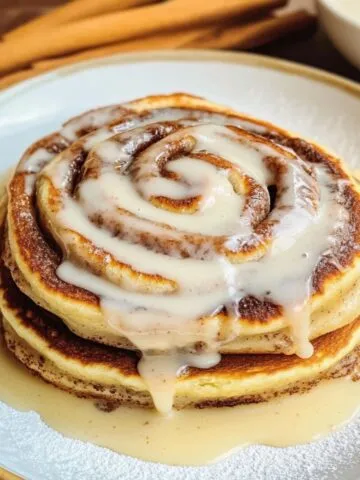 Fluffy cinnamon roll pancake recipe stacked with cream cheese glaze