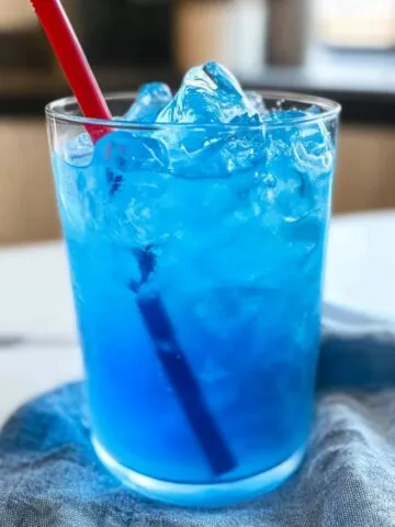 Glass of homemade Sonic Ocean Water with ice on a white kitchen counter