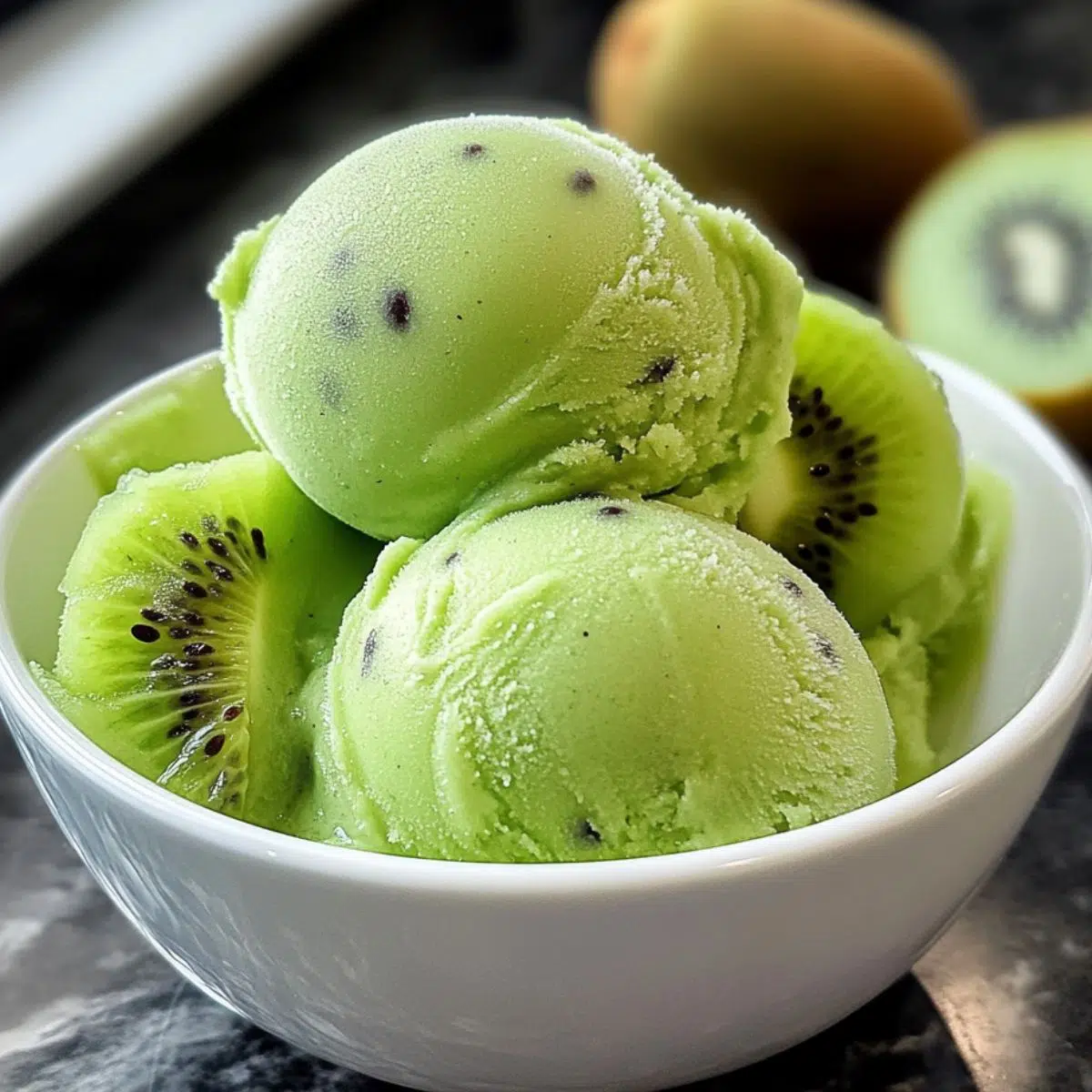 Homemade kiwi sorbet served in a bowl on a kitchen counter
