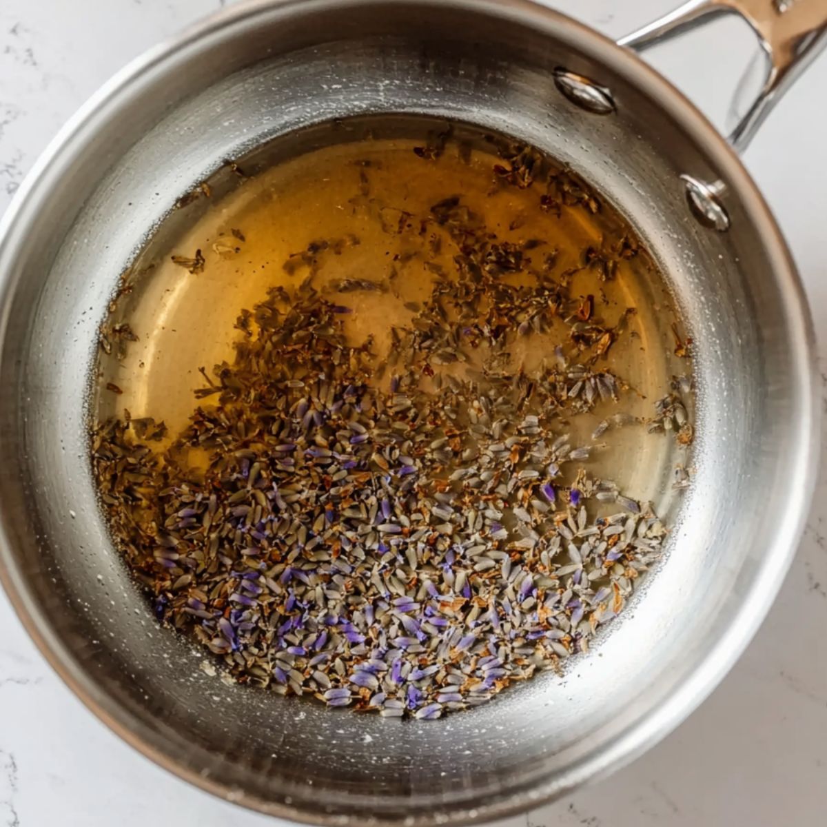Preparing lavender syrup with sugar and water in a saucepan