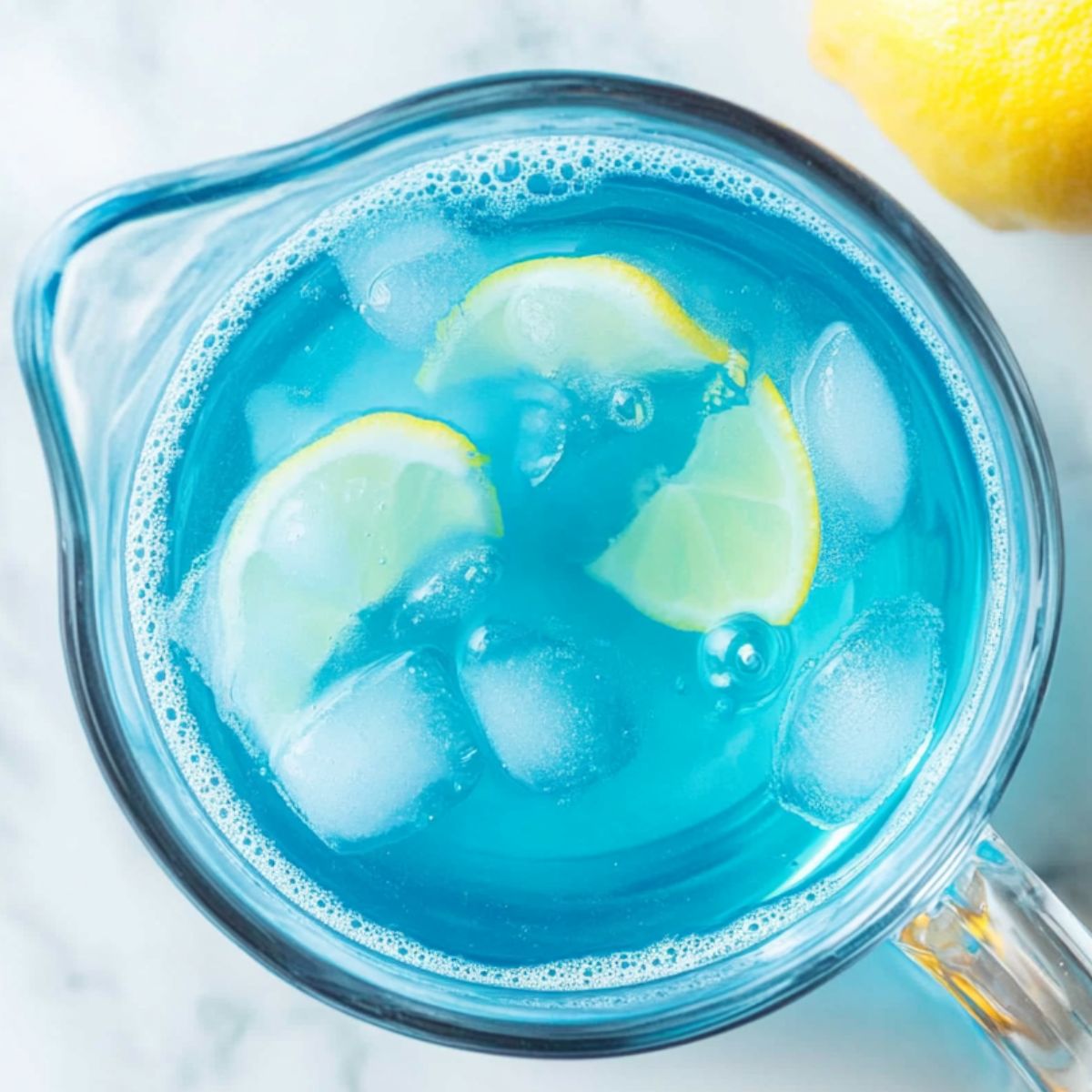  Mixing coconut extract and blue food coloring into a pitcher