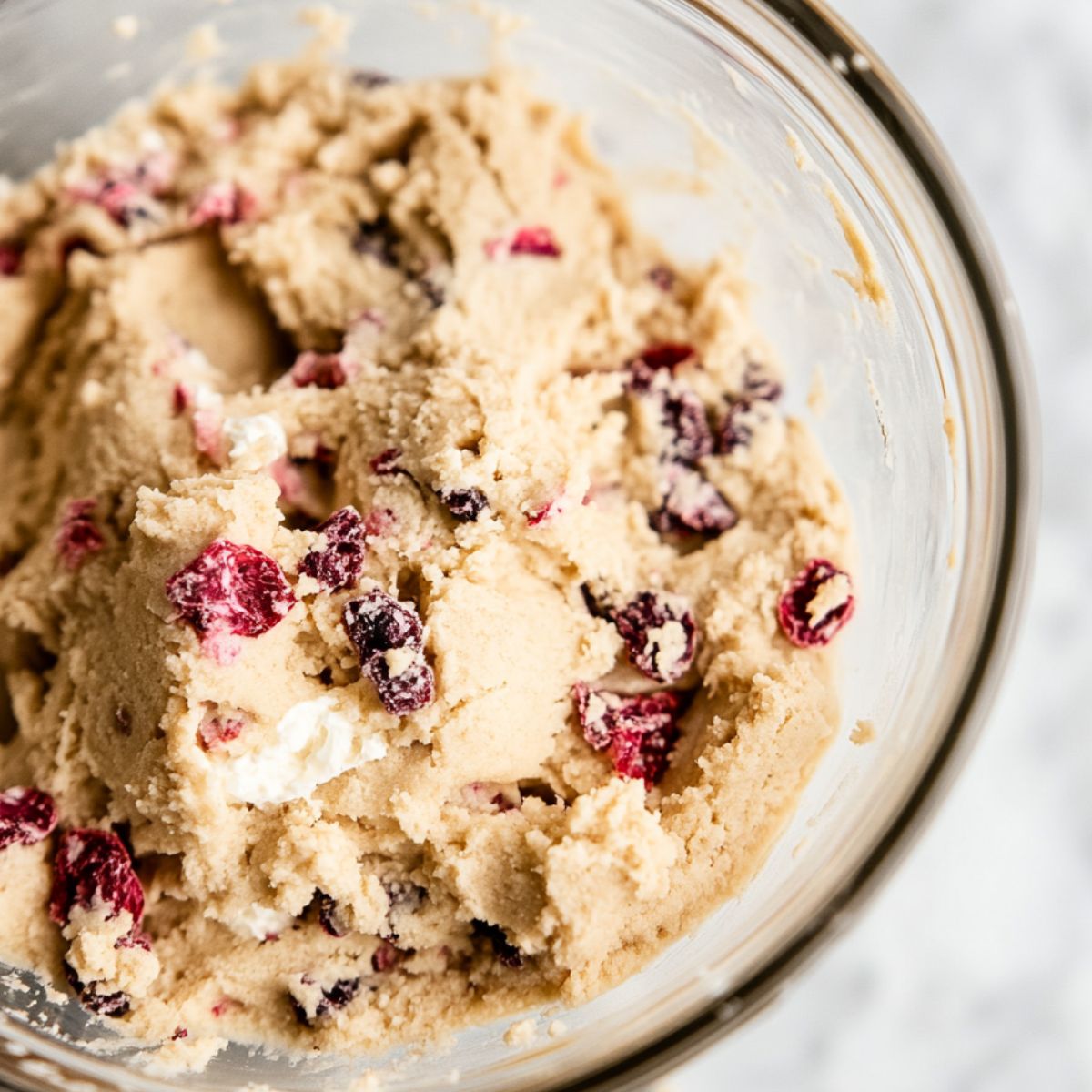 Mixing the strawberry cheesecake cookie dough with visible strawberry bits