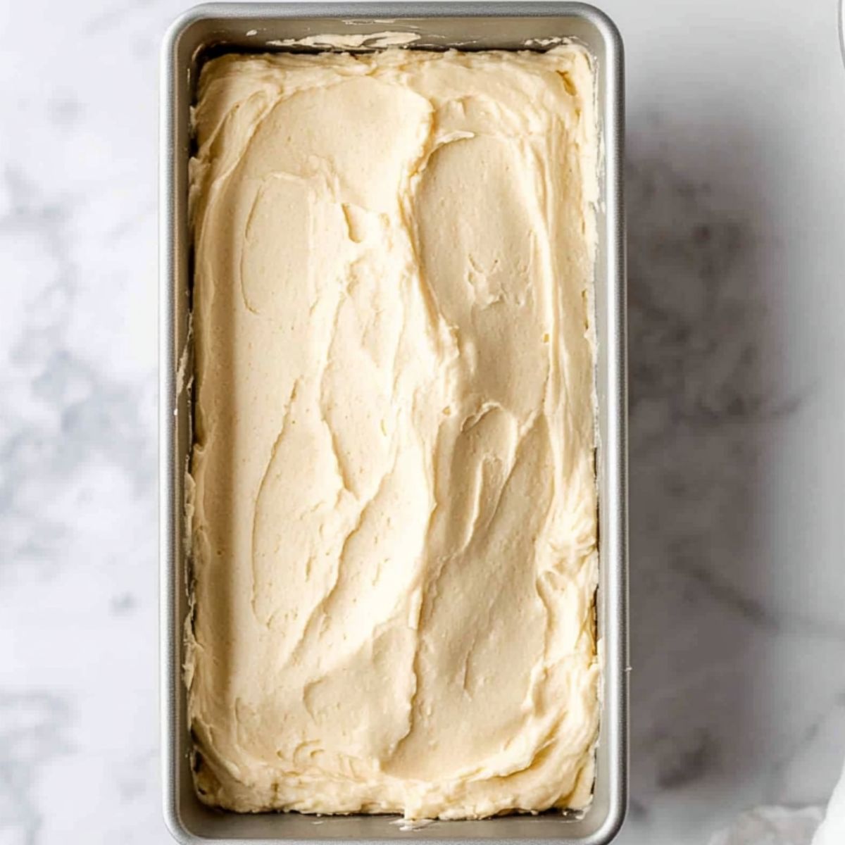 Unbaked lemon lavender cake batter in loaf pans, ready for the oven.
