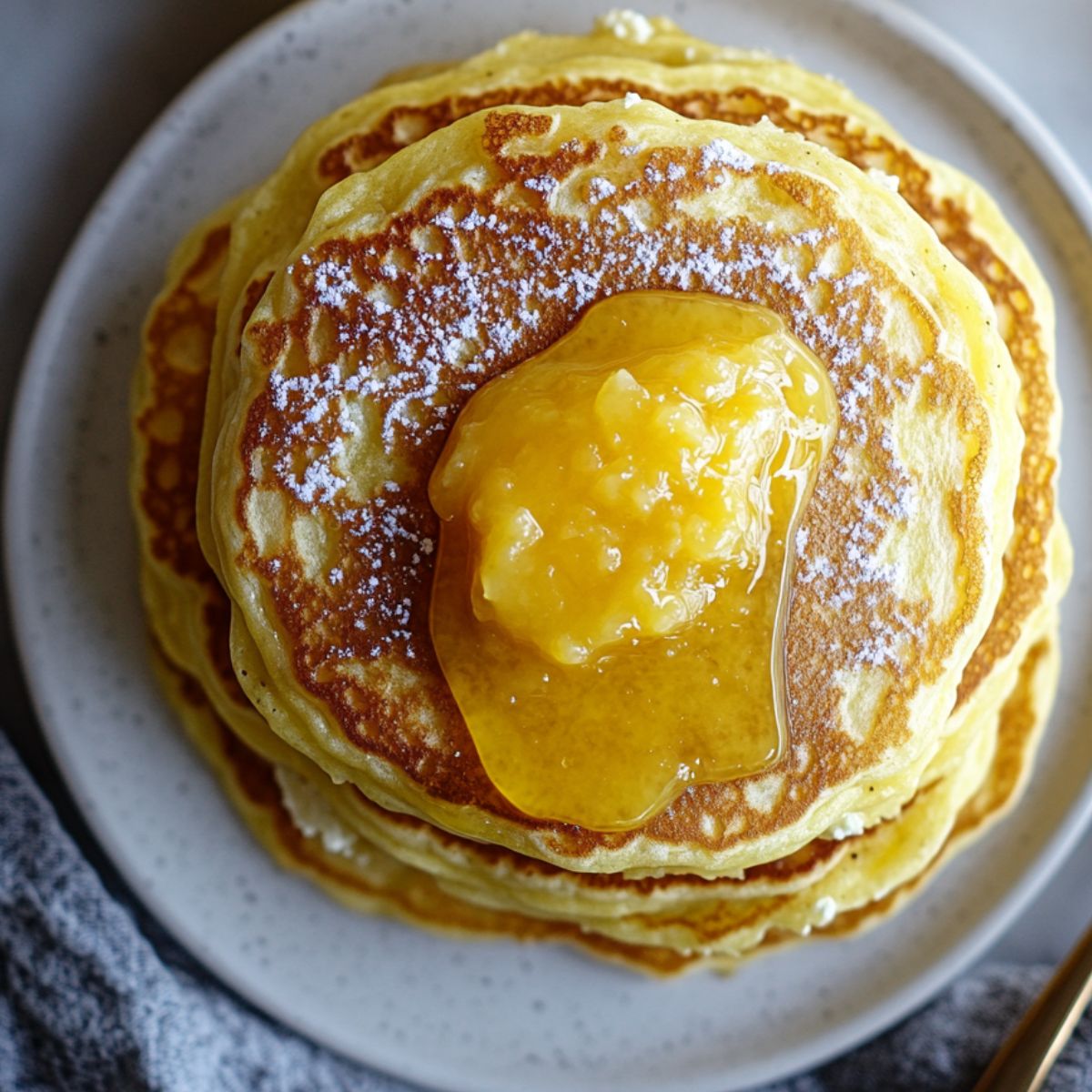 Served stack of Lemon Curd Ricotta Pancakes 