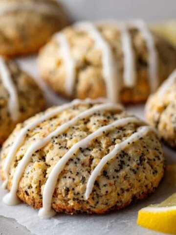 Freshly baked lemon poppy seed cookies with glaze on a white kitchen counter, homemade style