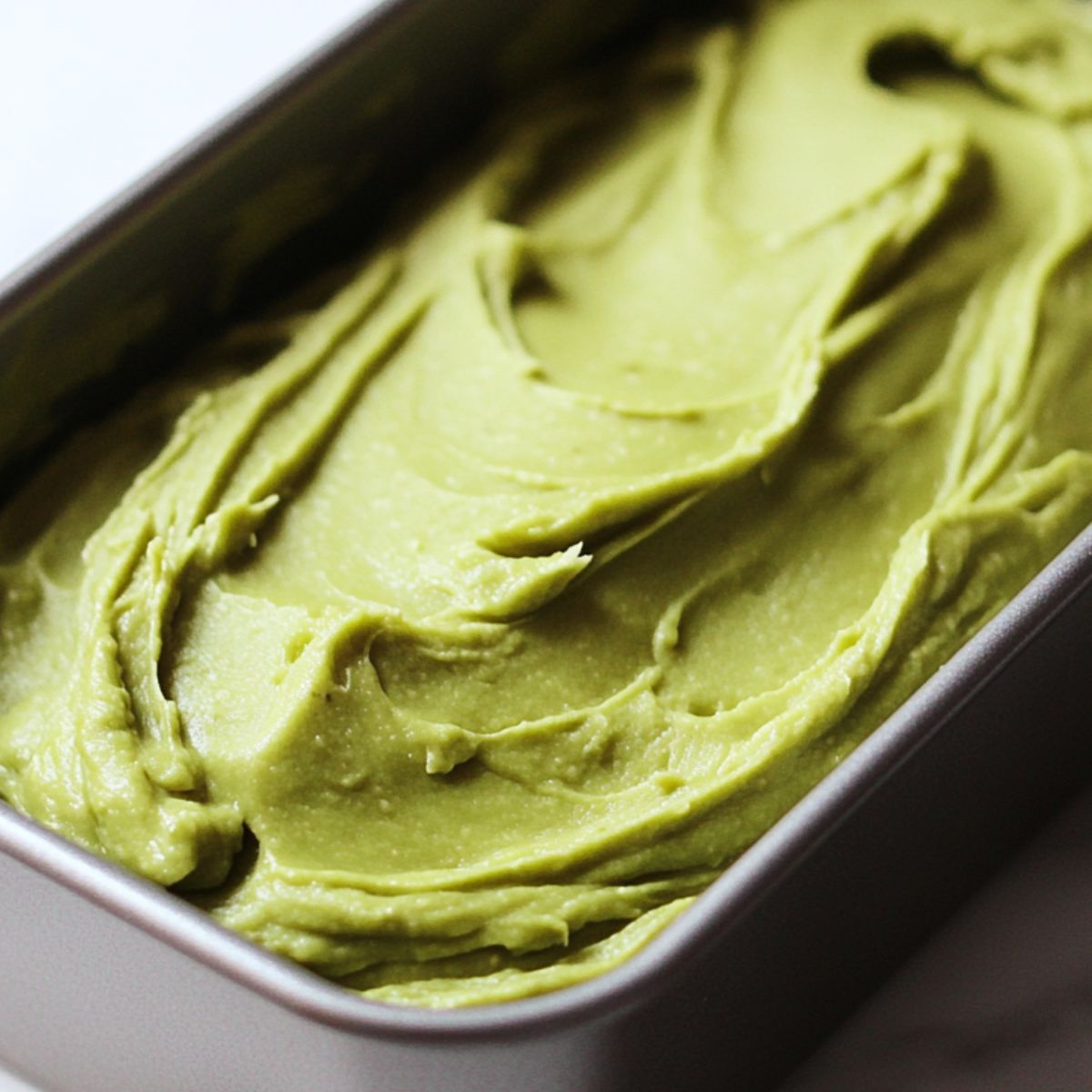 Avocado bread baking in a loaf pan