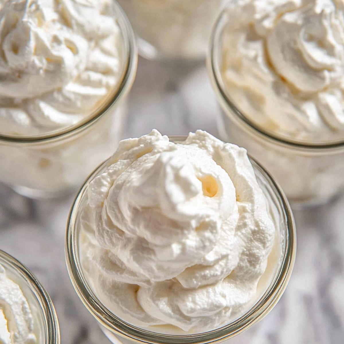 Finished cheesecake fluff in small serving jars reeqdy to be plqced in the fridge.