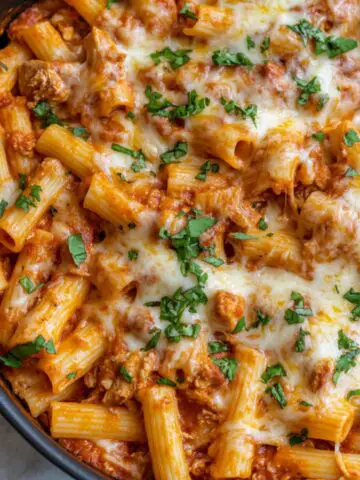 Enchilada pasta served with creamy sauce and melted cheese.