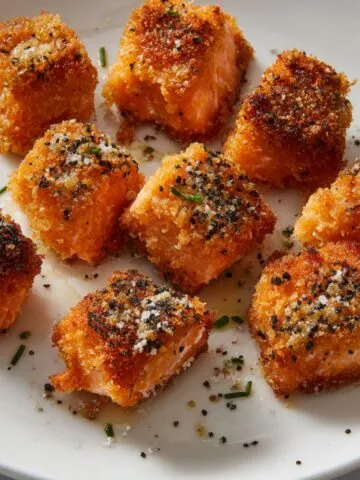 Air fryer crispy salmon bites on a white plate, golden and crunchy