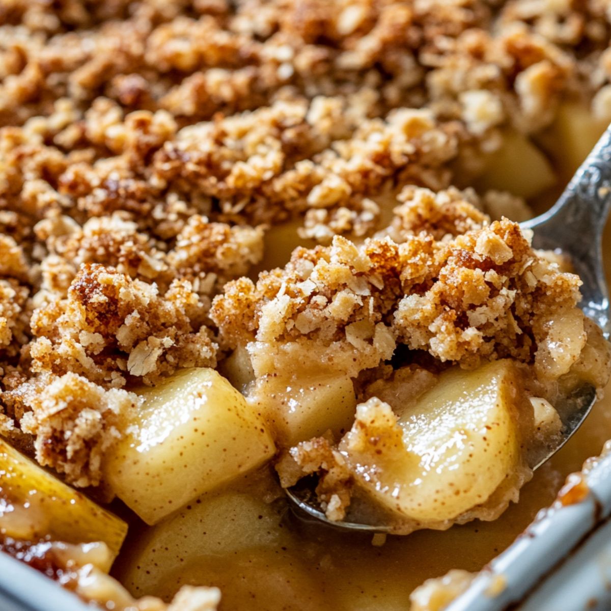 Serving a warm slice of breakfast apple crumble from the baking dish