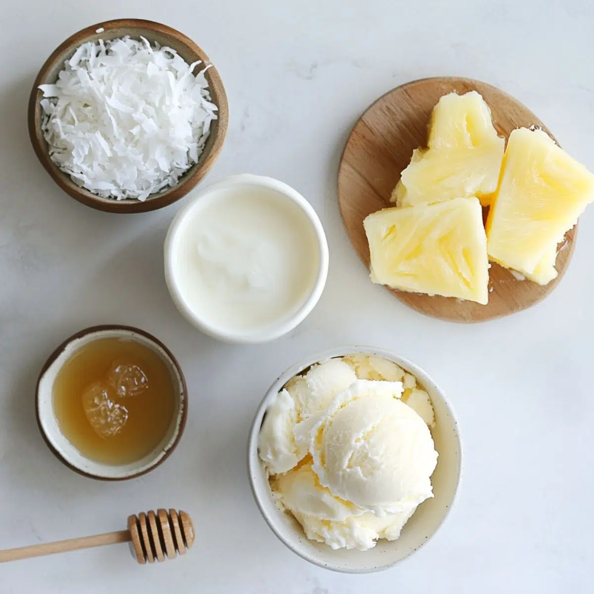 Ingredients for making a pina colada milkshake laid out on a kitchen counter