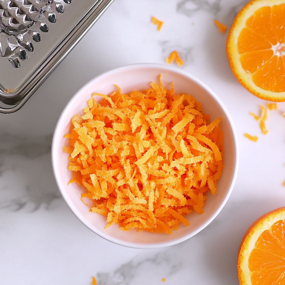 Zesting and juicing fresh oranges for homemade iced tea
