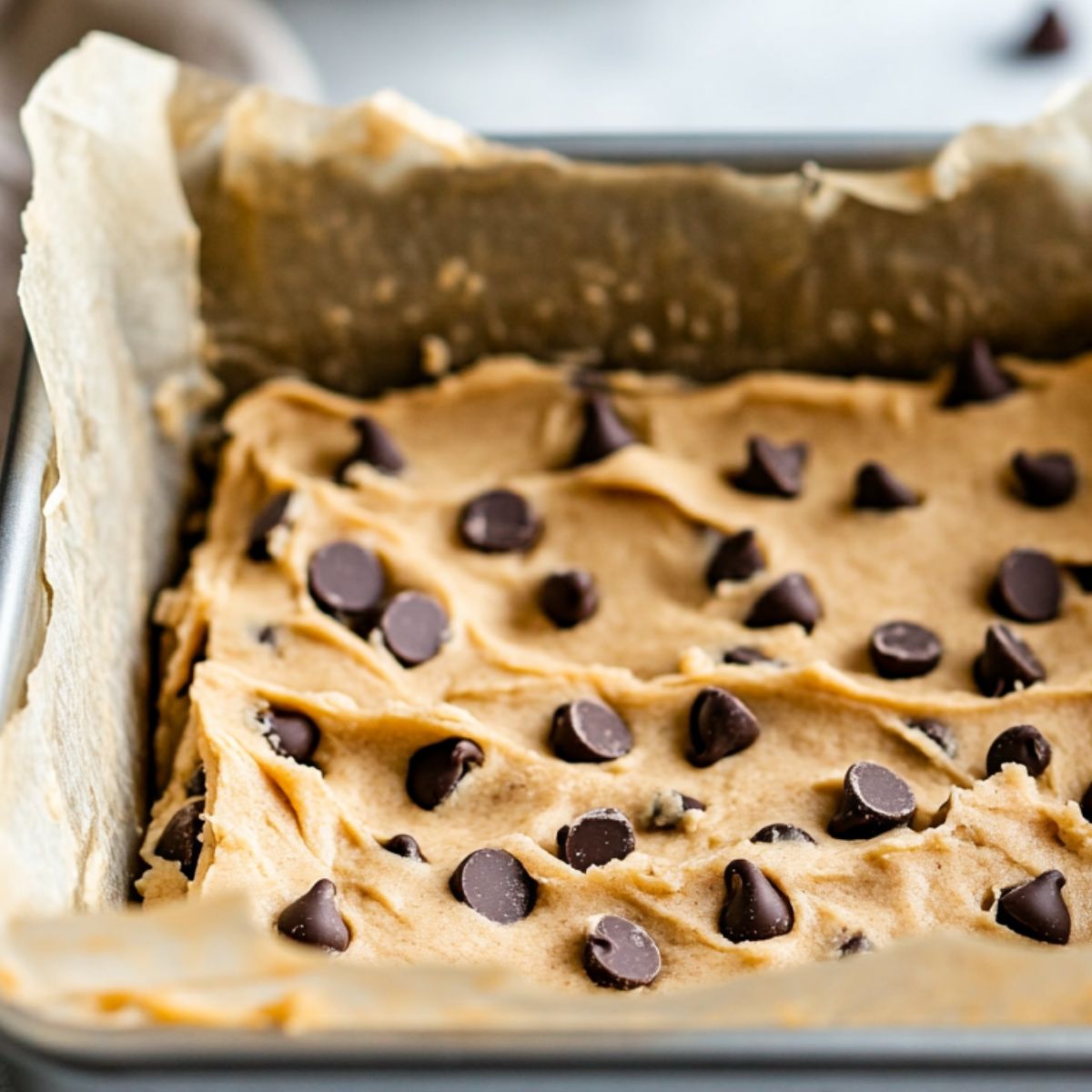 Cookie dough bars pressed into a pan, ready to chill
