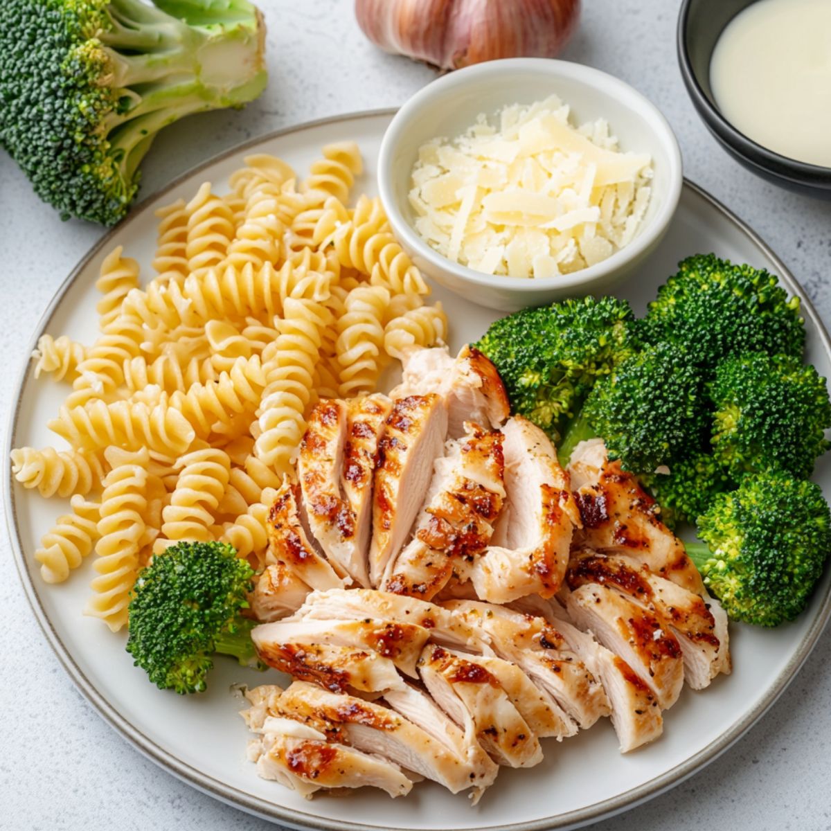 All the ingredients laid out for making rotisserie chicken broccoli pasta