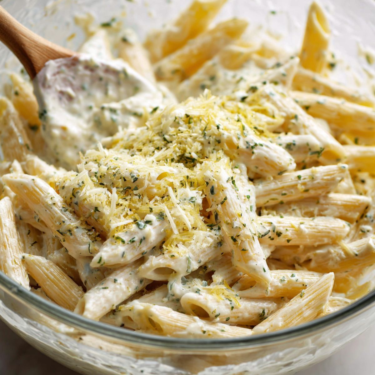 Freshly mixed lemon basil ricotta pasta in a large bowl being served