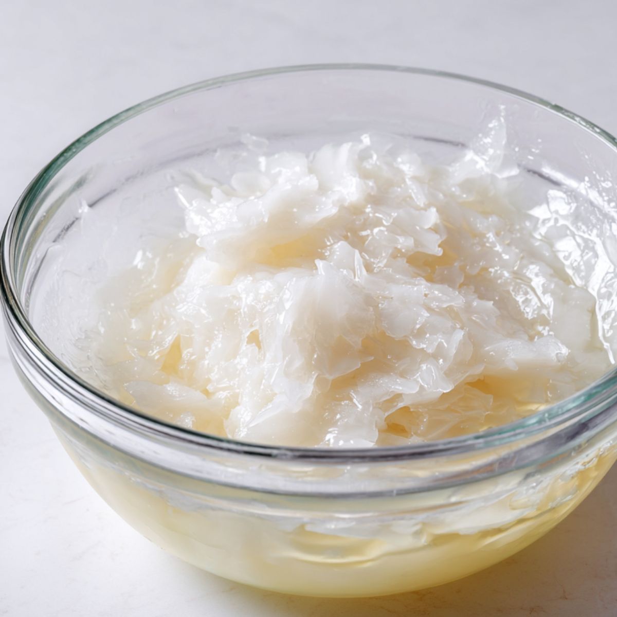 Translucent cooked milk mochi dough in a bowl on a kitchen counter