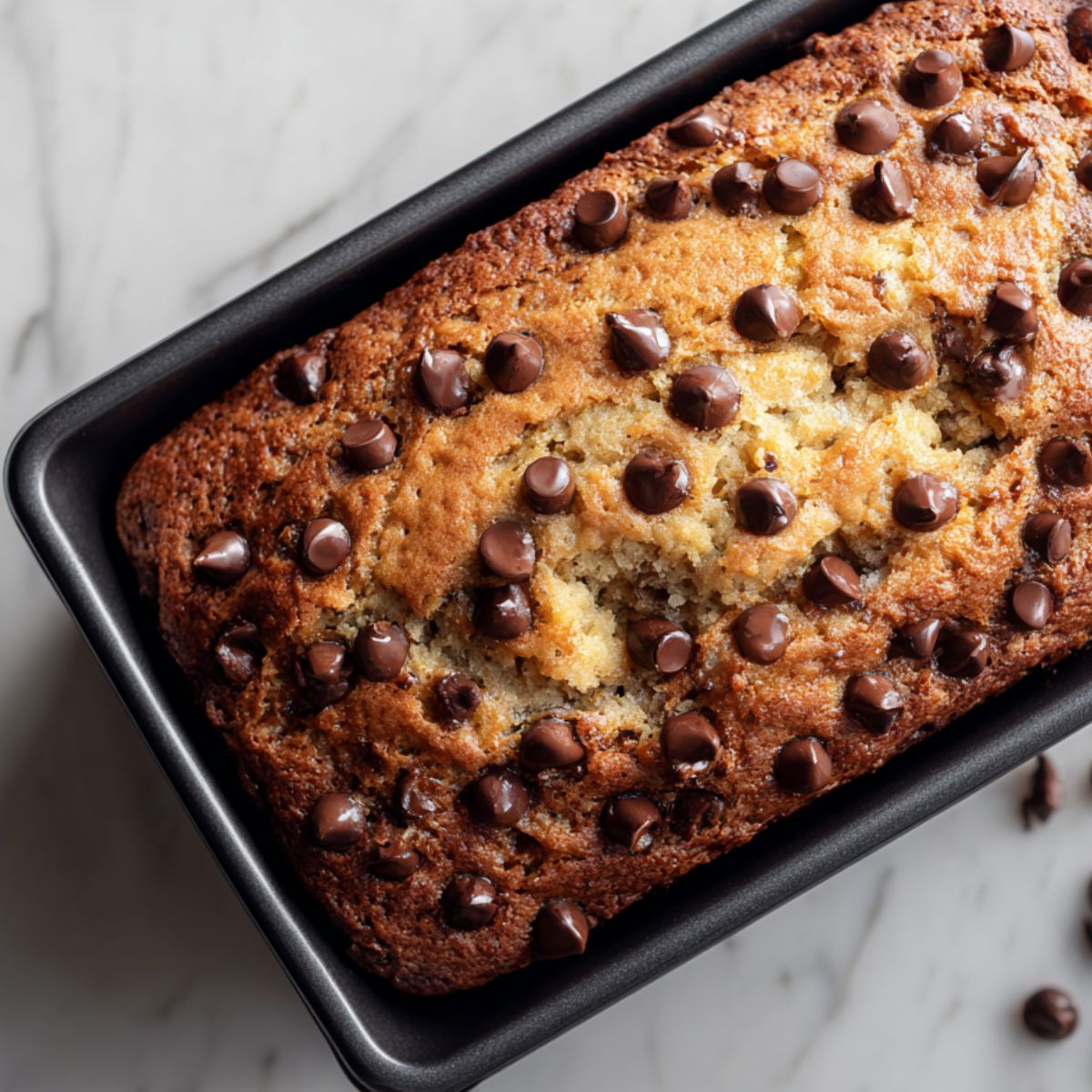 Banana bread loaf baking with golden brown top