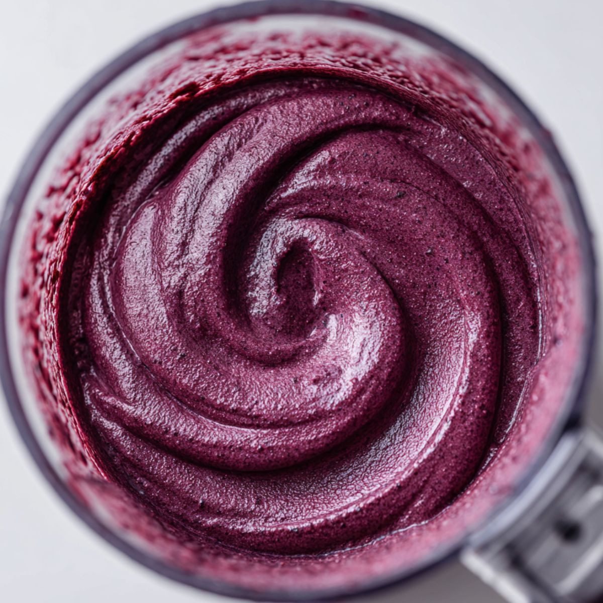 Blending acai into a thick soft-serve consistency