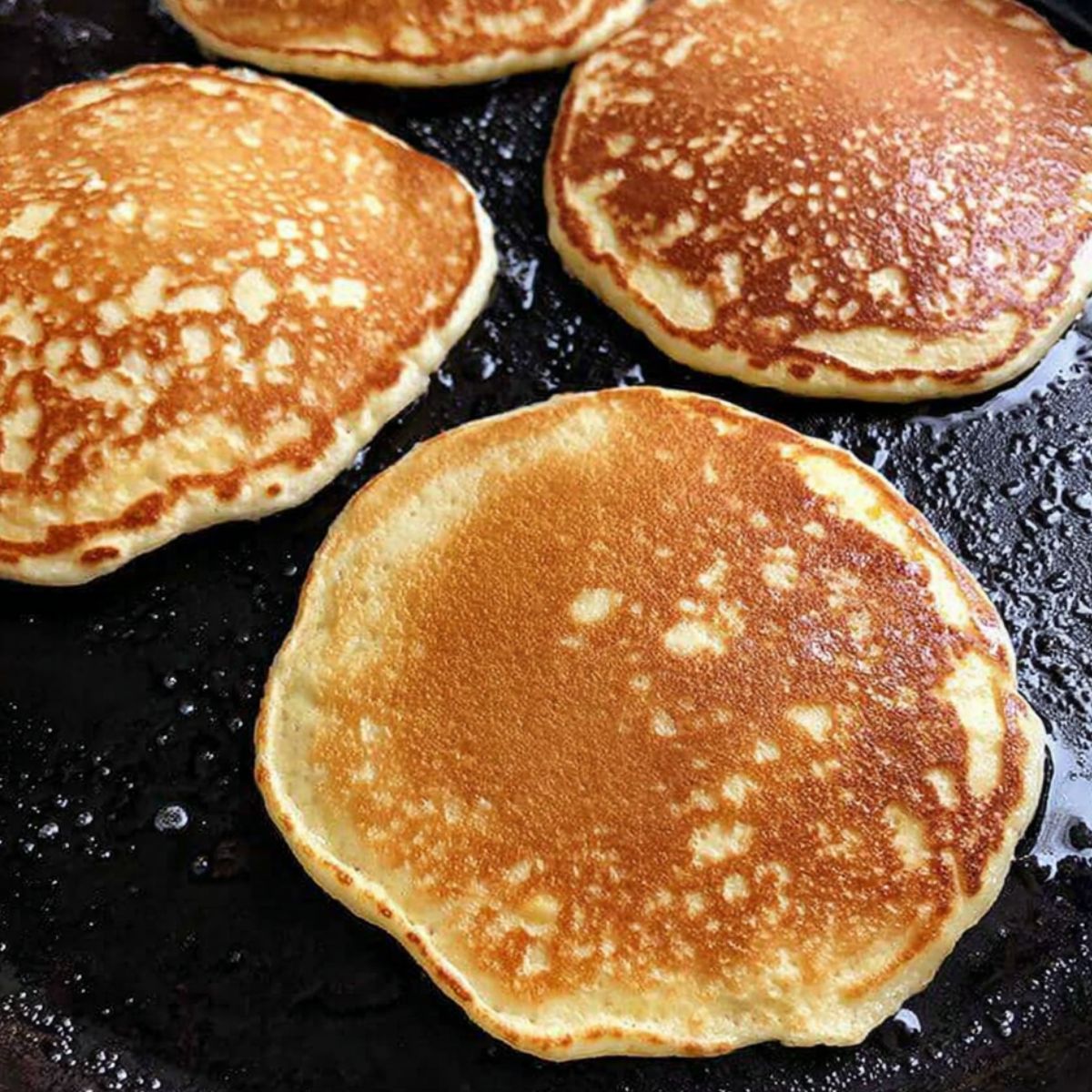 Cooking golden pancakes on griddle