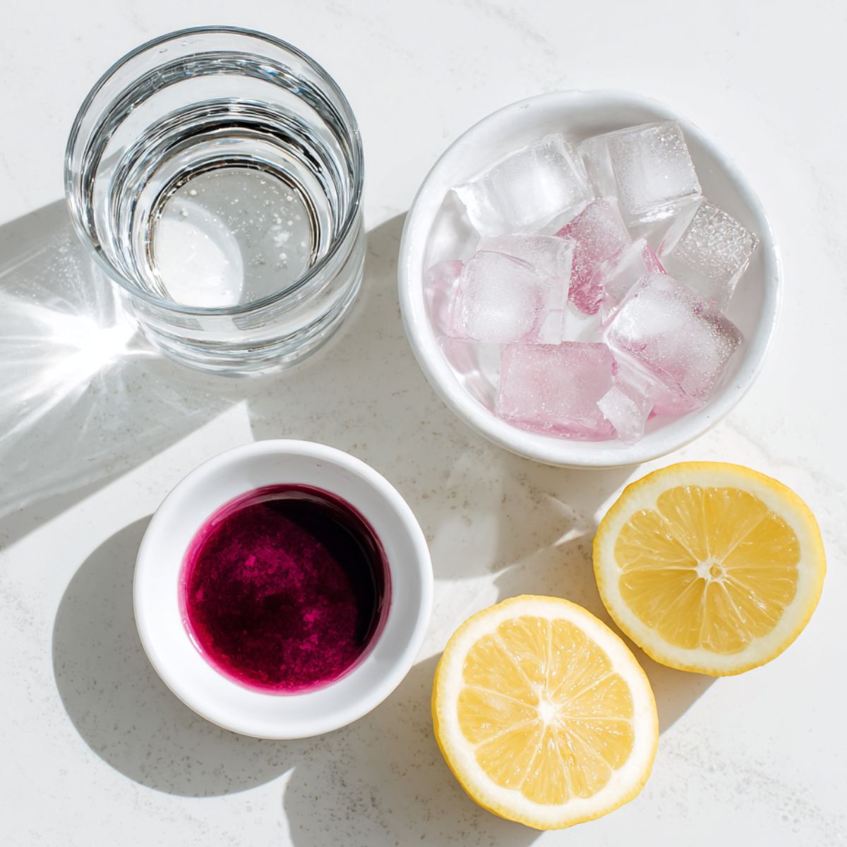  Ingredients for making a cotton candy mocktail laid out on a kitchen counter