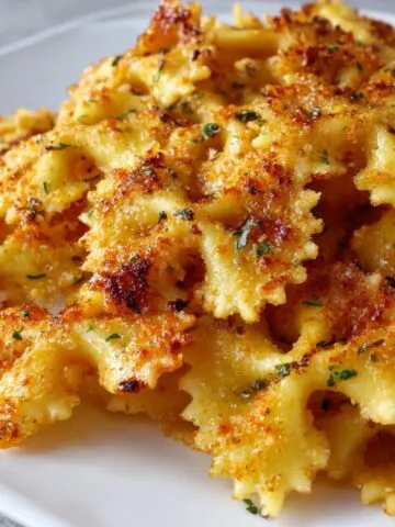 Crispy golden baked pasta chips on a white kitchen counter in a casual homemade setting.
