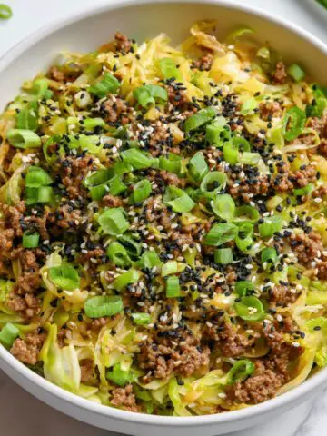 Overhead view of a homemade keto egg roll in a bowl served in a white ceramic bowl