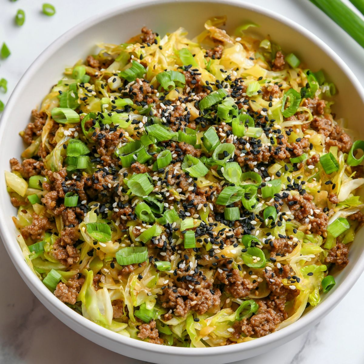 Overhead view of a homemade keto egg roll in a bowl served in a white ceramic bowl