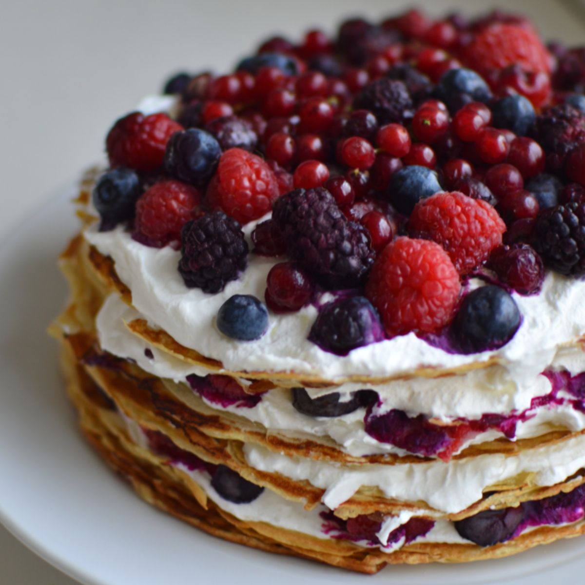 Homemade pancake cake with berries and cream