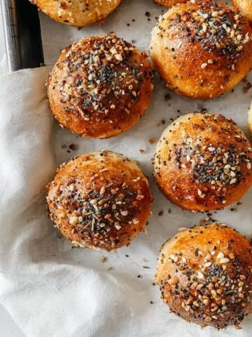 Baked Bagel Bites on a tray with everything seasoning and napkin edge