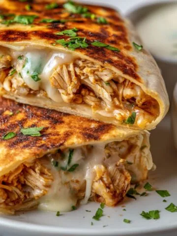 Homemade Cheesy Garlic Chicken Wraps on a white counter