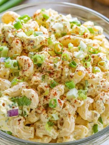 Homemade deviled egg pasta salad in a white bowl on a kitchen counter