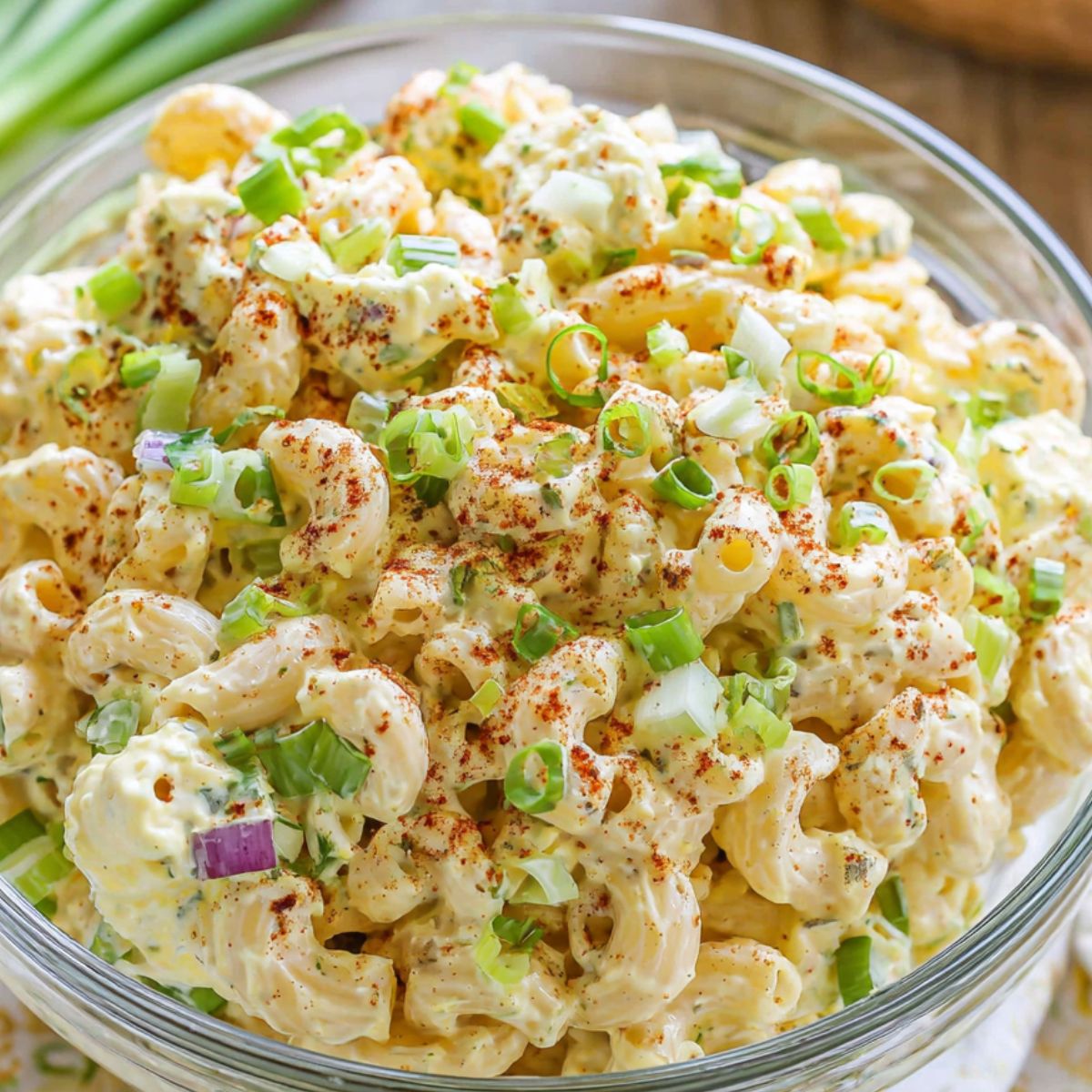 Homemade deviled egg pasta salad in a white bowl on a kitchen counter