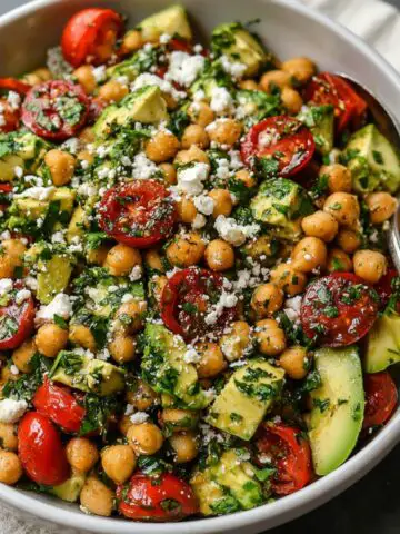 Chickpea Feta Avocado Salad served in a white bowl on a kitchen counter