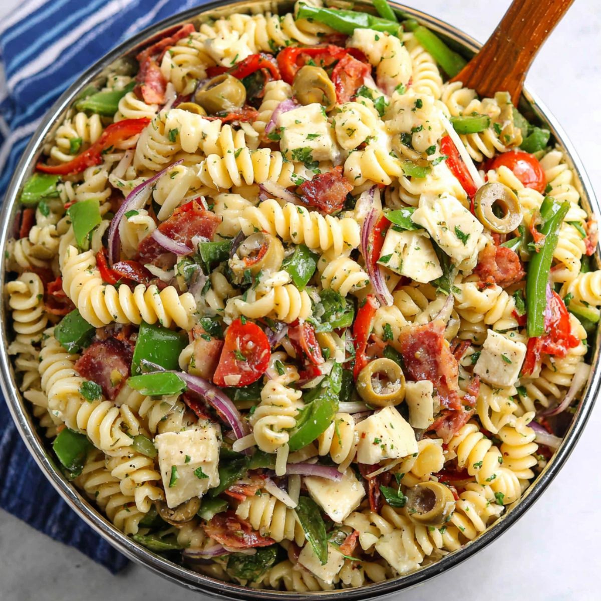 Homemade pizza pasta salad recipe served in a bowl on a kitchen counter