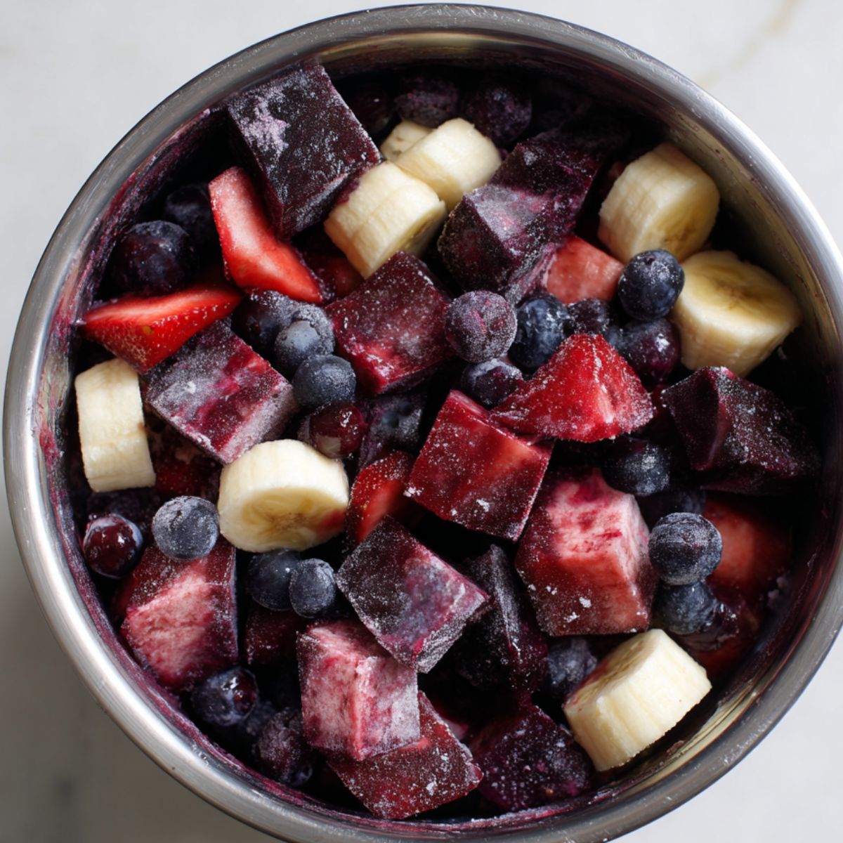 Preparing frozen ingredients for an acai bowl on a kitchen counter
