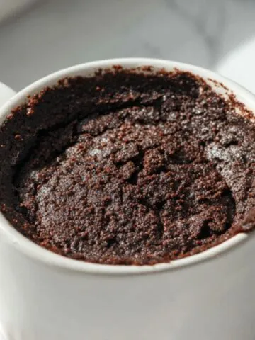 Warm protein brownie cooling in a mug