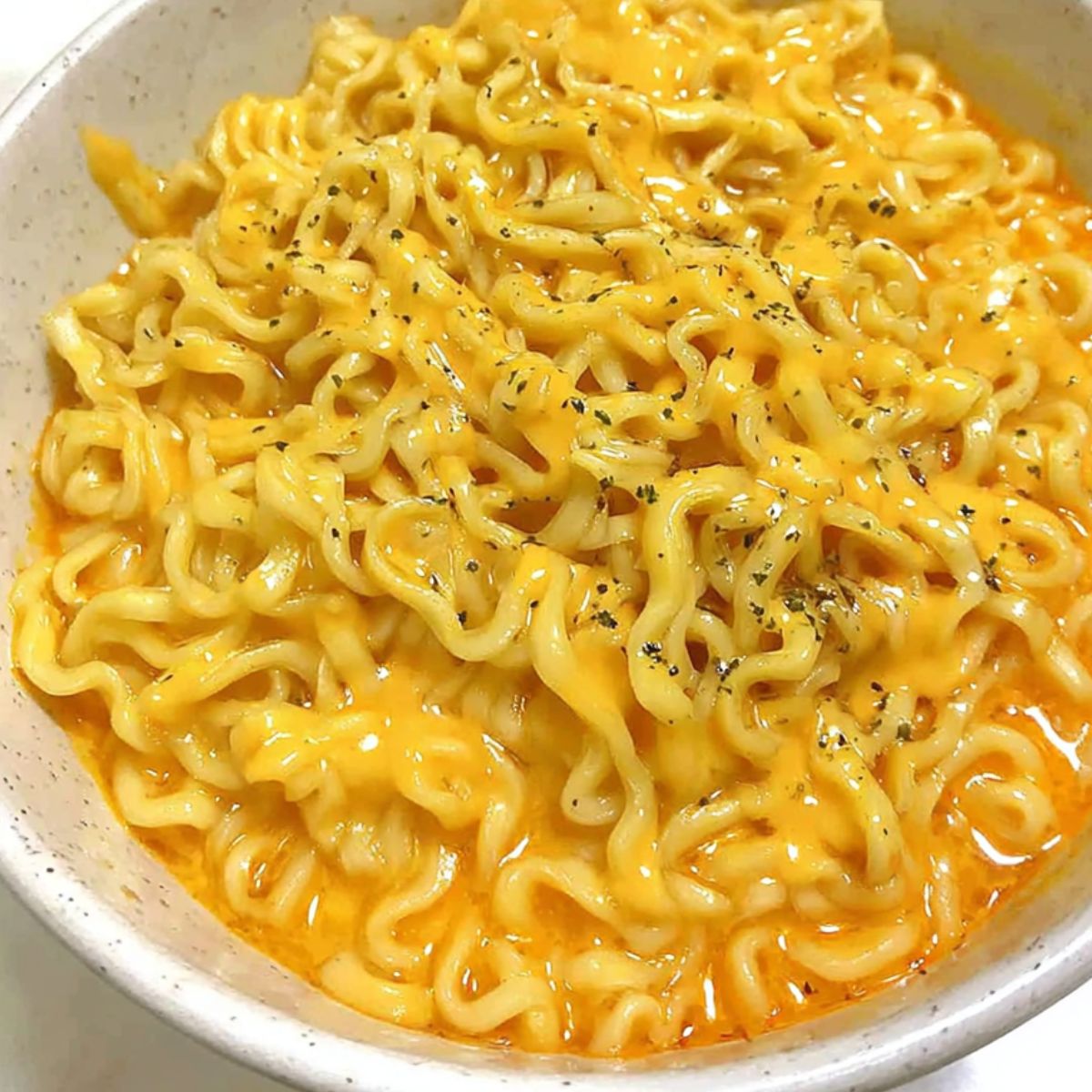 A bowl of cheesy ramen resting before serving.