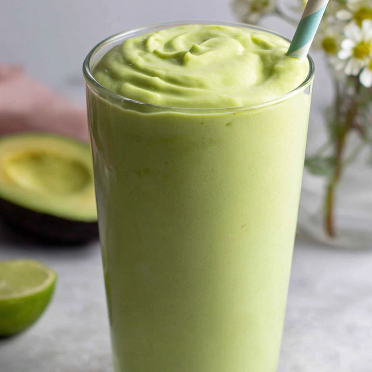 Freshly poured Vietnamese avocado smoothie in a tall glass