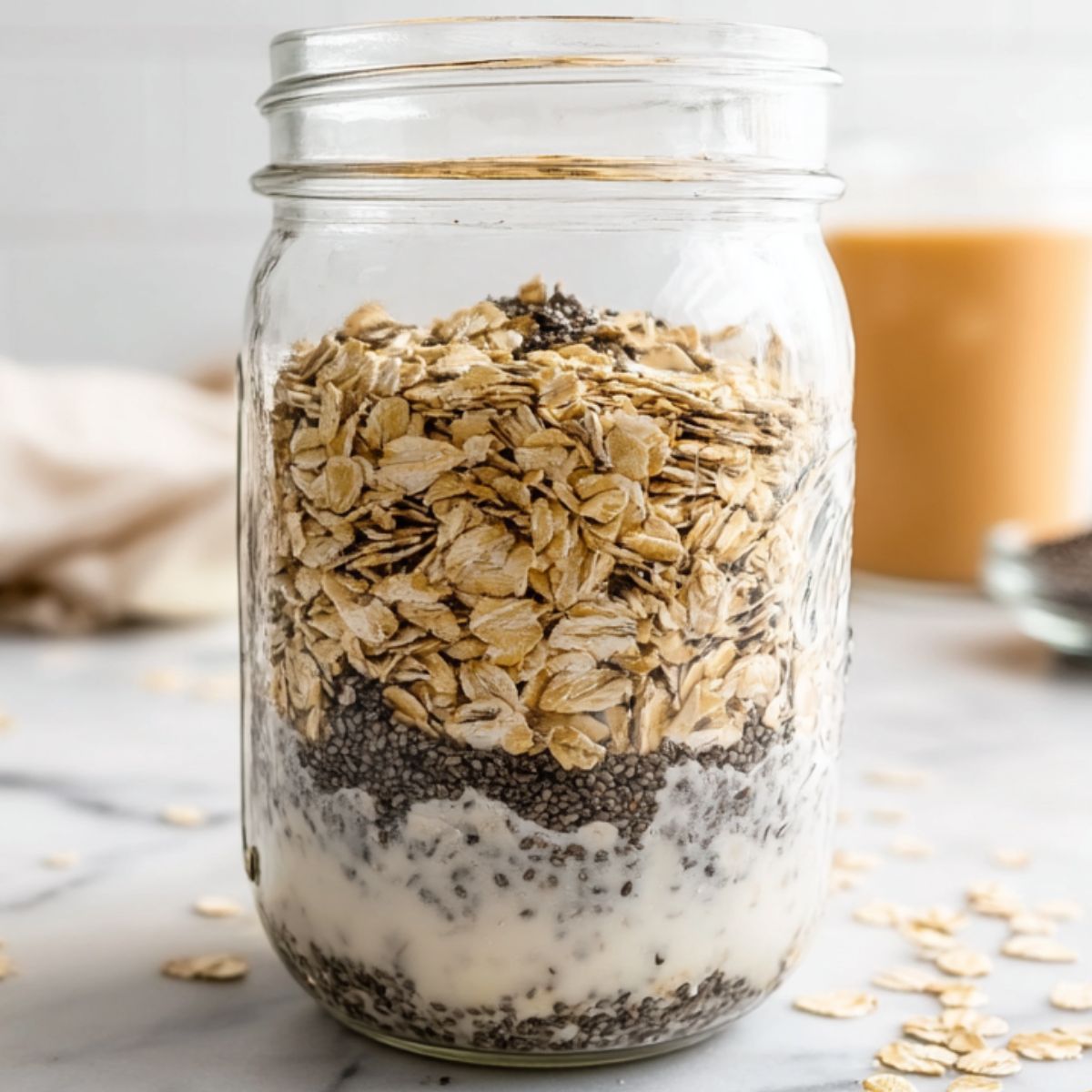 Mixing oats, protein powder, and chia seeds in a jar.