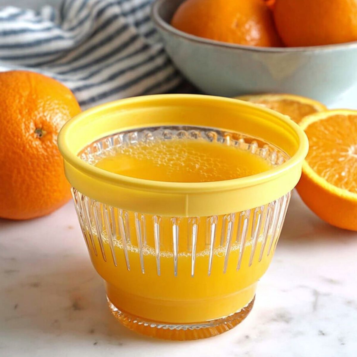 Squeezing fresh orange juice with a citrus reamer